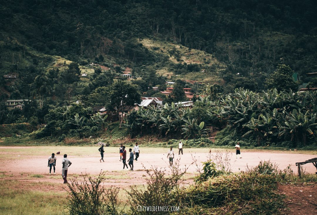 Local kids playing soccer on a field in Ranomafana town